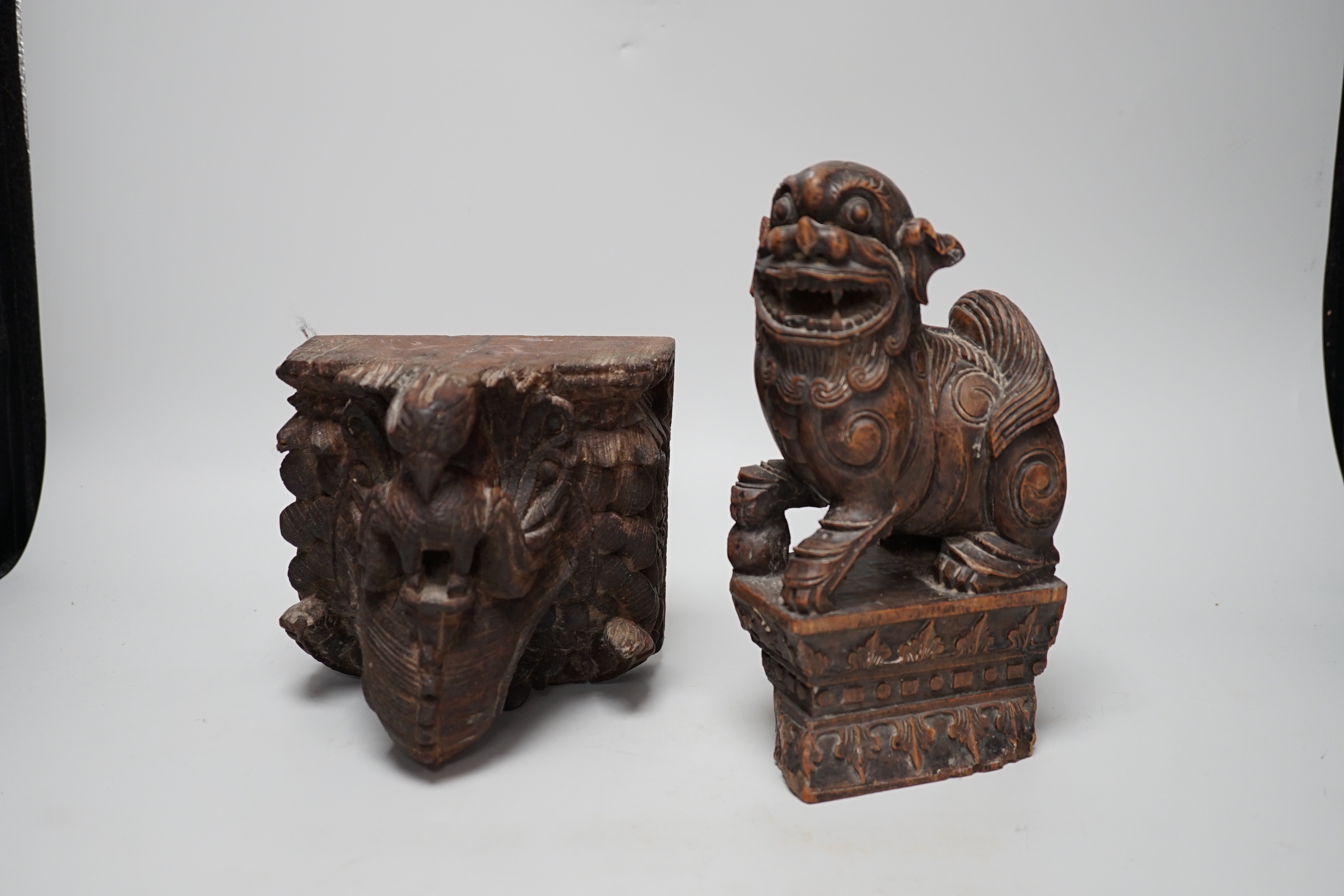 A carved Chinese hardwood temple lion and wall bracket (2) tallest 23cm